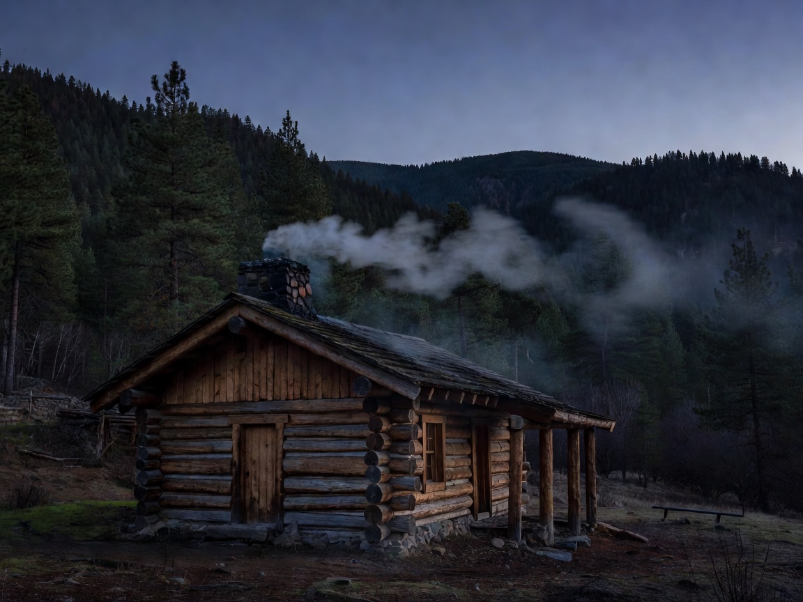 Timber mountain cabin with woodsmoke drifting against dark pine hills